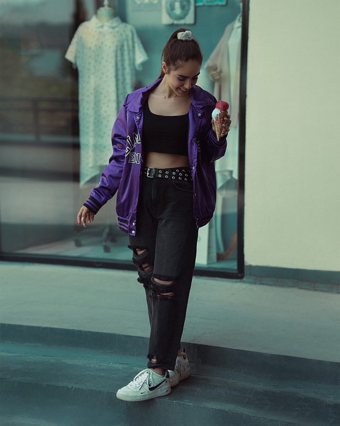 a woman wearing a purple jacket
