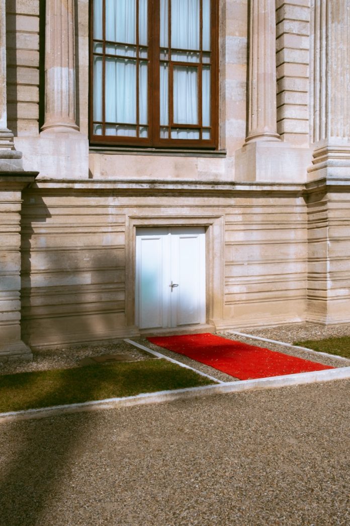 a red carpet on the ground in front of a building